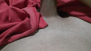 Naked young man masturbating big thick cock under the blanket